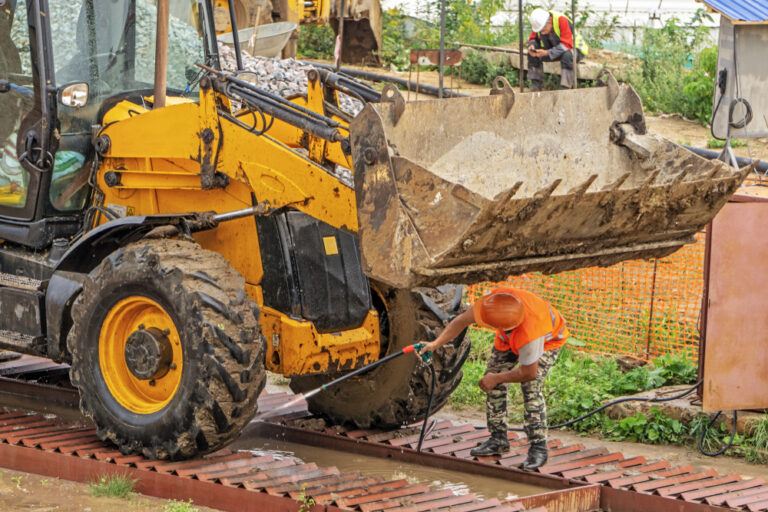 Driver,At,The,Construction,Site,Washes,The,Excavator,On,The